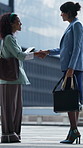 Business, handshake and women with tablet in city, greeting or partnership for property development. Teamwork, shaking hands or happy people with joint real estate venture, tech or urban project deal