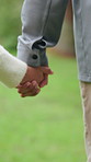 Person, walk and holding hands with child outdoor for travel, adventure and bonding together. Family, parent and support with kid for fresh air, explore nature and relationship connection on vacation