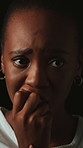 Fear, anxiety and black woman with biting nails in studio, stress and concerned expression for phobia. Scared, worry and person with trauma for emotional distress, nervous habit and dark background
