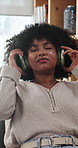 Headphones, relax and woman by desk in home listening to music, podcast or radio on app. Calm, audio tech and female person in living room with streaming playlist or album in apartment on weekend.