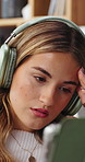 Headphones, tablet and woman on sofa in home listening to music, podcast or radio on app. Relax, audio tech and female person in living room with streaming playlist or album in apartment on weekend.