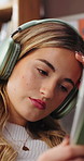 Headphones, relax and woman on sofa with tablet in home listening to music, podcast or radio on app. Calm, audio tech and female person in living room with streaming playlist or album in apartment.