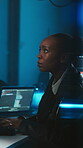 Hacker, programming and woman with computer screen in office, ransomware or financial fraud at night. Serious, criminal and black person with tech for cyber attack, working late and coding online