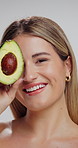Skincare, beauty and face of woman in studio with avocado for natural, organic or hydration routine. Portrait, glow and female person with fruit for facial dermatology treatment by white background.