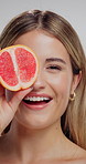 Face, beauty and woman in studio with grapefruit for natural, organic or hydration routine. Skincare, portrait and female person with citrus fruit for facial dermatology treatment by white background