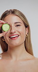 Skincare, face and woman in studio with cucumber for natural, organic or hydration routine. Beauty, glow and portrait of female person with fruit for facial dermatology treatment by white background.