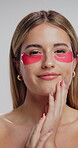 Eye patch, skincare and face of woman in studio for fine line treatment, hyaluronic acid and beauty. Cosmetics, collagen mask and self care with person on white background for dermatology and glow