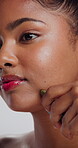 Skincare, gua sha and massage with woman in studio for lymphatic drainage, self care or detox. Facial tools, holistic treatment and natural beauty with person on white background for circulation