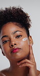Cream, cosmetics and face of woman in studio for dermatology, self care and collagen. Glow skincare, hydration and beauty with person on white background for lotion, clear skin and moisturizer