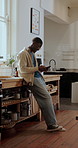 Typing, laughing and black man in kitchen, phone for online chatting and app for communication. Happy, mobile user and African person in home, tech for comedy and scroll for entertainment or smile
