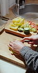 Cooking, hands and man in kitchen, cutting and prep for vegetarian meal, knife and nutrition. Organic recipe, wooden board or person in home, above or vegetables for vegan diet, salad or healthy food