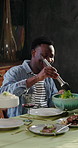 Lunch, friends and man in home, salad for nutrition and social gathering for reunion party. Group, apartment and people with celebration, healthy meal and community with snack, funny and happiness