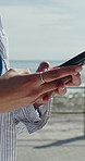 Ocean, hands and woman with phone, internet for online chatting and message to contact. Seaside, location and person with tech for social media,  connection for texting and download for tourism info
