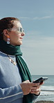 Seaside, walking and woman with phone, thinking and message to contact, typing and internet. Ocean. location and person with tech for social media, reflection for break and download for tourism info