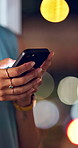 Hands, phone and texting in office at night for client contact, global networking and CRM update. Woman, account manager and mobile chat at window for international query, portfolio review or bokeh