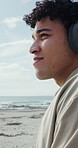 Happy man, relax and listening with headphones on beach promenade for audio streaming or music. Male person, stress relief and comfort with fresh air or sound for podcast or playlist on ocean coast