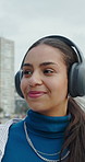 Headphones, walking and woman by beach for holiday with listening to music, playlist or radio. Happy, audio tech and person on promenade by ocean for streaming album on vacation or weekend trip.