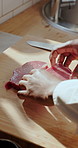 Kitchen, steak and hands of chef with chopping board for cuisine, dinner and gourmet recipe. Cooking, catering and person with meat, protein and food for meal prep, nutrition and culinary skills