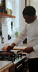 Kitchen, cooking and chef with steak in pan for meal prep, cuisine and recipe at restaurant. Hospitality, catering and black man with meat in pan for dinner, lunch and food for culinary skills