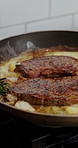 Pan, cooking and steak with sizzle on kitchen stove for hospitality, meal prep or cuisine. Empty, food or heat with ingredients, meat or rosemary seasoning for dinner, recipe or catering service