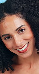 Skincare, smile and face of woman in studio with natural beauty, cosmetics or facial glow. Confident, happy and portrait of female person with dermatology for wellness by blue background in Colombia.