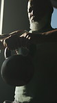 Gym, training and man with kettlebell for fitness, exercise and bodybuilding for muscle development. Serious, mature bodybuilder and black person with equipment for workout, wellness and endurance