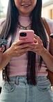 Hands, texting and group with phone in city, university students and networking with contact on app. Outdoor, happy woman and chat on social media with mobile, friends and communication at college