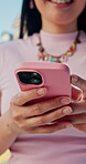 Texting, online and hands with phone in city, communication or chat with contact on social media app. Outdoor, networking and person with smile for message, scroll and typing with mobile on website