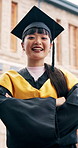 Face, graduation and Asian woman with arms crossed on campus, celebration and education milestone. Outdoor, portrait and happy student with confidence for college achievement, academic goals or laugh
