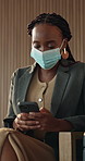 Businesswoman, typing and phone in office with mask, virus prevention or break for social media post. Black person, PPE and scroll in lobby with tech, text message or protection for infection control