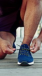 Hands, runner and tie with shoelace in city with fitness, start and posture for launch with speed in summer. Man, outdoor and ready with training in running shoes, balance or exercise in urban town