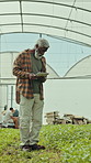 Farmer, man and tablet in greenhouse with inspection, monitor crop growth and agro research report. Person, farming and typing in nursery with tech, quality control or sustainability for agriculture.