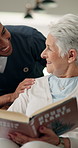 Smile, caregiver and old woman with book at house for checkup, medical support and bonding. Happy, nurse or reading novel with senior patient for assisted living, friendly interaction and supervision