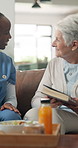Smile, caregiver and old woman with food in home for checkup, medical support and assisted living. Nurse, healthy meal and senior patient with story book, friendly interaction and healthcare services