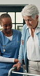 Nurse, old woman and support with walker in home for mobility, smile or helping hand in retirement. People, caregiver and elderly patient with disability, walking frame or rehabilitation at house
