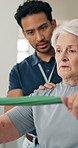 Physiotherapist, resistance band or senior woman in clinic for support, talking or strength exercise. Speaking, stretching or old person with assistance for rehabilitation, mobility recovery or help
