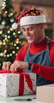 Christmas, office and man opening gift for celebration, tradition and secret santa for supply chain. Business, shipping and person with present, box and surprise for festive season, xmas and holiday
