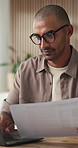 Man, typing and document in office with laptop, review or report insight for digital marketing project. Person, glasses and draft proposal in business with computer, paperwork or advertising feedback