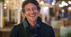 Happy man, face and night with laugh in city for travel, outdoor commute or tourism on bokeh. Male person, traveler or tourist with smile in late evening for fun location or destination in urban town