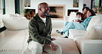 Laughing, talking and man with family in home living room for comfort, happiness and relax on weekend. Father, children and joke in house to chill with security, wellness and conversation on sofa