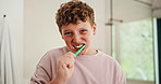 Bathroom, oral health and boy with toothbrush, brushing teeth and cavity prevention with toothpaste. Clean, mouth and child with dental care equipment for fresh breath, face and hygiene in house