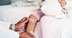 Doctor, hands and child with knee band aid on bed for bruise, medical injury or fall in home visit. Healthcare, pediatrician or leg plaster with teddy bear or bandage for accident or wound protection