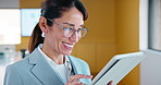 Businesswoman, smile and typing in office with tablet, glasses and good news for financial audit report. Happy, mature person and scroll in firm with tech, positive feedback and email for accounting.