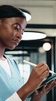 Nurse, woman and writing in hospital with tablet, review and online research for medical internship. Female person, healthcare intern and digital notes with tech, stylus and reading for case study.