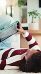 Child, reading and elearning with tablet in home, growth or skill development with assignment on web. Online education, kid and girl with tech for knowledge, research and digital activity in house