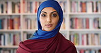Education, face and Muslim woman in school library for development, knowledge or teaching. Books, learning and religion with Arab teacher on campus for college or university course and curriculum