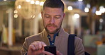 Night, businessman and commute in city with phone, check schedule or thinking for text message response. Evening, bokeh and person travel downtown with tech, scroll social media or review work agenda