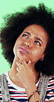 Confused, thinking and black woman with face in studio, problem solving and brainstorming for solution. Portrait, decision and happy person with eureka moment for idea, laughing and green background