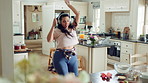 Woman, dance and fun with headphones in kitchen, meal prep and moving with energy in home and silly. Happy person, singing and rhythm with phone for music, cooking and celebration with tech in house