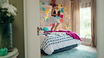 Dancing, bed and girl with teddy bear for happy holiday or weekend play at home. Dancer, ballet and child jumping in bedroom with toy, imagination or excited energy for childhood fun or celebration